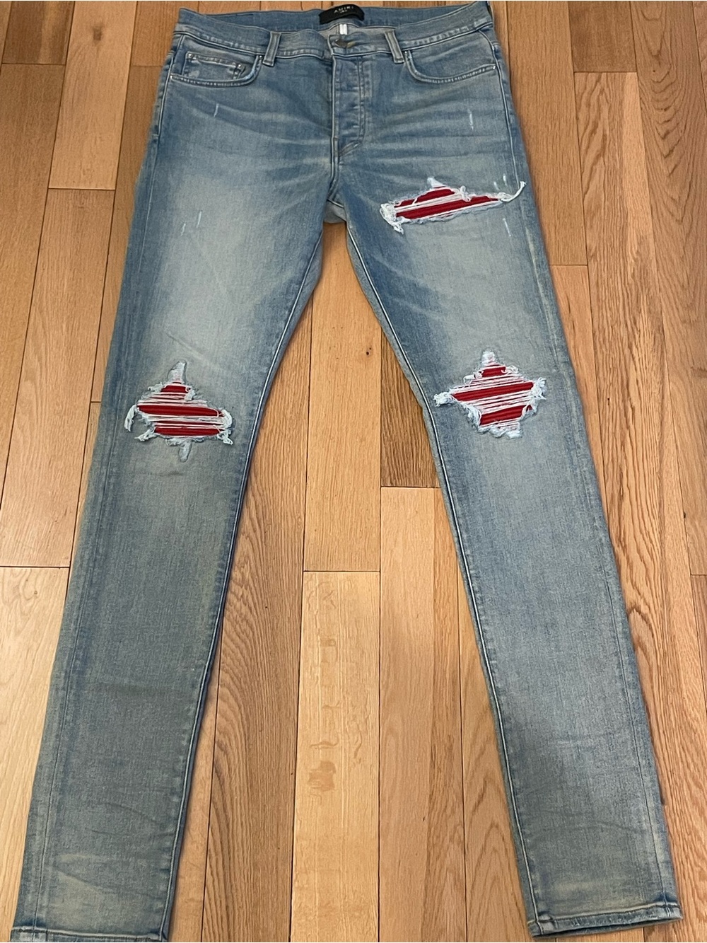 AMIRI Light Blue Skinny Jeans with Red Striped Patch Accents